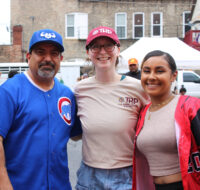 Group photo of three TRP staff members outdoors. They are facing the camera, standing and smiling.