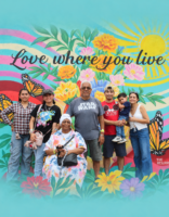 Family standing in front of a colorful mural.